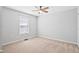 Neutral bedroom with a ceiling fan and a window providing plenty of natural light at 701 Prince Dr, Holly Springs, NC 27540