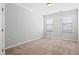 Neutral bedroom with two bright windows and neutral carpet at 701 Prince Dr, Holly Springs, NC 27540