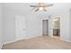 Bedroom with ceiling fan, and open bathroom doorway creating a spacious feel at 701 Prince Dr, Holly Springs, NC 27540