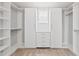 Spacious walk-in closet with custom shelves and drawers perfect for organization at 701 Prince Dr, Holly Springs, NC 27540