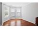 Empty room featuring hardwood floors, natural light, and neutral paint at 701 Prince Dr, Holly Springs, NC 27540