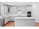 Updated kitchen with stainless steel appliances, gray cabinets, and stylish design at 701 Prince Dr, Holly Springs, NC 27540