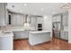 Well-lit kitchen with stainless appliances, gray cabinetry, and ample counter space at 701 Prince Dr, Holly Springs, NC 27540