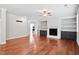 Cozy living room features hardwood floors, a fireplace with built-ins and great natural light at 701 Prince Dr, Holly Springs, NC 27540