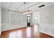 Bright living room featuring hardwood floors, natural light, and modern chandelier at 701 Prince Dr, Holly Springs, NC 27540