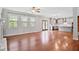 Open-concept living room flowing into kitchen, showcasing hardwood floors and natural light at 701 Prince Dr, Holly Springs, NC 27540