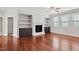 Comfortable living room showcases fireplace with built-ins and large windows for ample light at 701 Prince Dr, Holly Springs, NC 27540