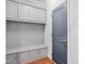 Mudroom offers built-in bench with storage, multiple cabinets, and convenient hanging hooks at 701 Prince Dr, Holly Springs, NC 27540