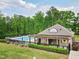 Community pool area with cabana seating, and well maintained landscape at 701 Prince Dr, Holly Springs, NC 27540