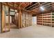 Unfinished basement with exposed wooden beams offers potential for customization at 705 Glen Eden Dr, Raleigh, NC 27612