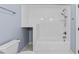 Bathroom features a tub with tile surround, sleek fixtures, and vanity at 705 Glen Eden Dr, Raleigh, NC 27612