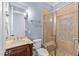Elegant bathroom featuring a glass shower with decorative tile and a stone countertop vanity at 705 Glen Eden Dr, Raleigh, NC 27612