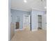 Light blue bedroom featuring neutral carpet, white trim, and a closet with shelves for ample storage at 705 Glen Eden Dr, Raleigh, NC 27612