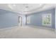 Spacious bedroom with light blue walls, plush carpet, and white plantation shutters for natural light at 705 Glen Eden Dr, Raleigh, NC 27612