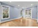 Large bedroom featuring hardwood floors, neutral paint, and large windows at 705 Glen Eden Dr, Raleigh, NC 27612