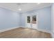 Light-filled room with wood floors and double doors leading to an outdoor patio area at 705 Glen Eden Dr, Raleigh, NC 27612