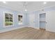Bedroom featuring wood floors, a ceiling fan, a closet, and two windows that bring the outside in at 705 Glen Eden Dr, Raleigh, NC 27612
