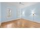 Well-lit bedroom with hardwood floors, light blue walls, and plantation shutters on the windows at 705 Glen Eden Dr, Raleigh, NC 27612