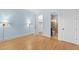 Bright bedroom with hardwood floors, blue walls, and classic trim, illuminated by sconces at 705 Glen Eden Dr, Raleigh, NC 27612