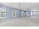 Expansive bedroom with natural light, neutral carpet, and ceiling fans at 705 Glen Eden Dr, Raleigh, NC 27612
