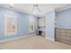 Bright bedroom featuring built-in cabinets, shelving and two windows at 705 Glen Eden Dr, Raleigh, NC 27612
