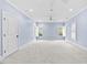 Airy bedroom featuring two windows, plush carpeting, and ceiling fan at 705 Glen Eden Dr, Raleigh, NC 27612