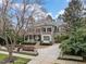 Stately home with a charming covered front porch, lush landscaping, and a welcoming entrance at 705 Glen Eden Dr, Raleigh, NC 27612