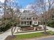 Elegant home featuring a covered front porch, manicured landscaping, and a spacious driveway at 705 Glen Eden Dr, Raleigh, NC 27612