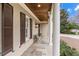 Inviting front porch with stone flooring, classic columns, and stylish accents, creating a cozy outdoor space at 705 Glen Eden Dr, Raleigh, NC 27612