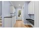 Hallway with hardwood floors, white wainscoting, counter space and cabinetry at 705 Glen Eden Dr, Raleigh, NC 27612