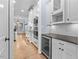 Modern kitchen with stainless steel appliances, wine cooler, and white cabinets at 705 Glen Eden Dr, Raleigh, NC 27612