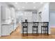 Spacious kitchen with a breakfast bar, white cabinets, stainless steel appliances, and ample counter space at 705 Glen Eden Dr, Raleigh, NC 27612