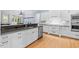 Open kitchen with granite countertops, stainless steel appliances, and white cabinetry at 705 Glen Eden Dr, Raleigh, NC 27612