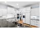 Well-equipped kitchen features granite countertops, stainless steel appliances, and white cabinets at 705 Glen Eden Dr, Raleigh, NC 27612