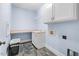Functional laundry room with cabinets, sink, and counter space at 705 Glen Eden Dr, Raleigh, NC 27612