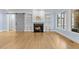 Bright living room boasts a stone fireplace, built-in shelving, and light hardwood flooring at 705 Glen Eden Dr, Raleigh, NC 27612