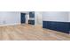 Open living room with custom blue cabinets, wood flooring, and modern finishes at 705 Glen Eden Dr, Raleigh, NC 27612