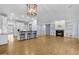Spacious living room featuring a fireplace, hardwood floors, and a breakfast bar to the kitchen at 705 Glen Eden Dr, Raleigh, NC 27612