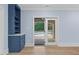 Blue cabinet with shelves beside glass doors which lead to the pool area at 705 Glen Eden Dr, Raleigh, NC 27612