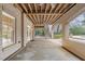 Covered brick patio with stairs leading up to the backyard offers a charming outdoor space at 705 Glen Eden Dr, Raleigh, NC 27612