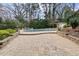 Outdoor pool surrounded by brick patio and lush landscaping provides a luxurious retreat at 705 Glen Eden Dr, Raleigh, NC 27612
