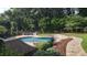 Beautiful backyard pool with stone accents, lush landscaping, and an inviting outdoor lounge area at 705 Glen Eden Dr, Raleigh, NC 27612