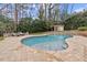 Beautiful backyard oasis with an in-ground pool, waterfall feature, and lush landscaping at 705 Glen Eden Dr, Raleigh, NC 27612