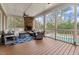 Enjoy a luxurious screened porch with a stone fireplace, ample seating, and a view of the pool at 705 Glen Eden Dr, Raleigh, NC 27612