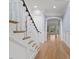 White staircase with natural light and view to the living area at 705 Glen Eden Dr, Raleigh, NC 27612