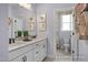 Bright bathroom featuring double sink vanity, ample mirror, and view of toilet at 72 Cultivator Ct, Angier, NC 27501