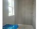 Shower room with tiled walls, window, and shower caddy at 72 Cultivator Ct, Angier, NC 27501