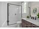Bathroom featuring a walk-in glass shower, a modern vanity with sink, and stylish patterned tile floors at 72 Cultivator Ct, Angier, NC 27501