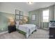 Charming bedroom featuring green accent wall, natural light and warm lamps at 72 Cultivator Ct, Angier, NC 27501