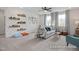 Bright bonus room featuring stylish decor, plush seating, and abundant natural light from large windows at 72 Cultivator Ct, Angier, NC 27501